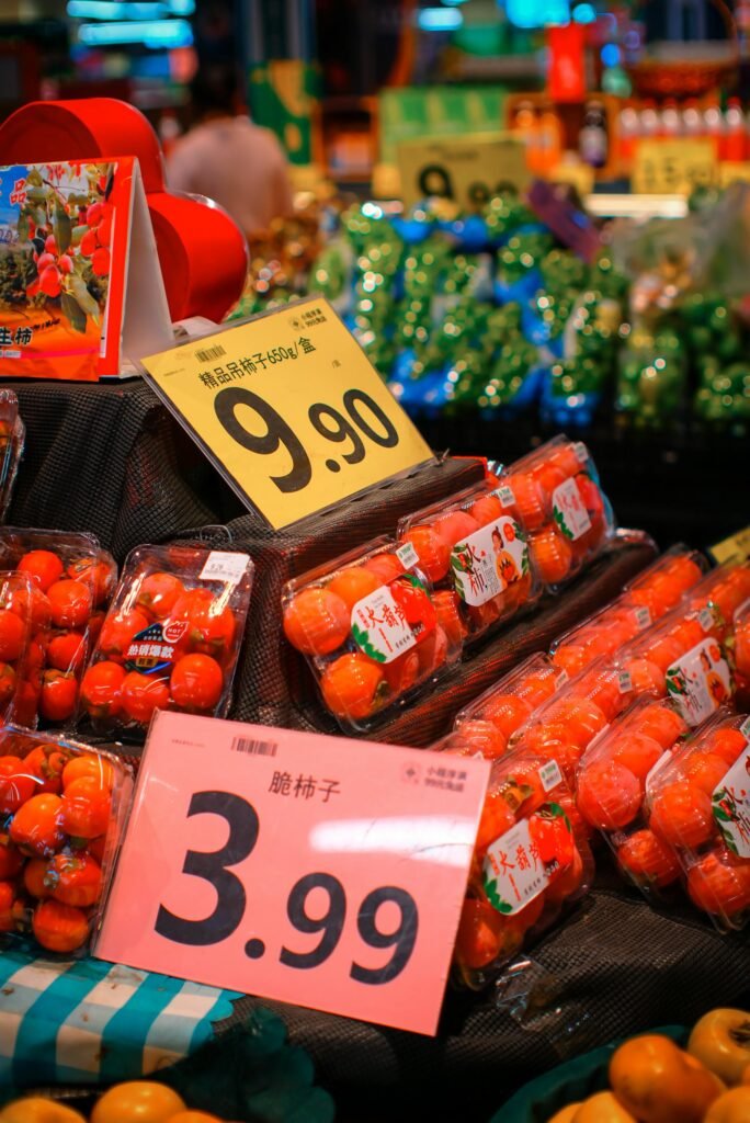 Colorful market stall displaying fresh fruits and vegetables with price signs.